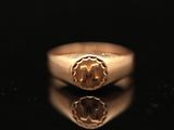 a close up of a gold ring with a diamond in the center