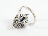 an image of a silver ring with a blue stone in the center