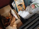 a box full of books and a teapot on a table