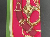 a pink box with a gold and red design on it