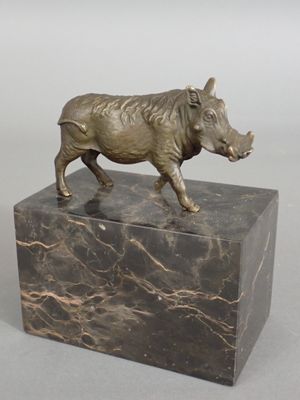 statue of a boar on a marble base on a gray background