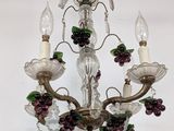 a chandelier with a bunch of grapes hanging from it