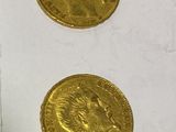 three gold coins sitting next to each other on a table