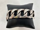 bracelet made of silver metal on black leather cushion