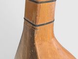 a close up of a wooden vase on a table