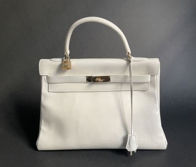 a white leather handbag on a black background