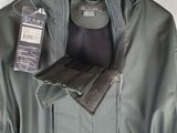 a close up of a jacket on a hanger on a wall