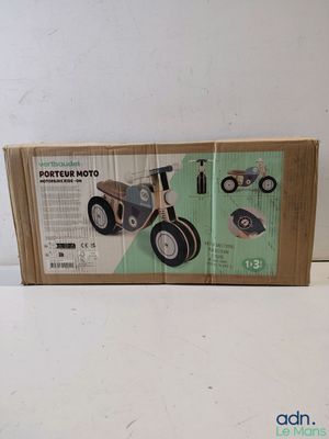 a box with a toy bike in it on a table