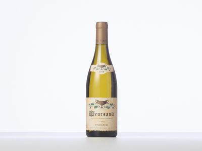 a bottle of white wine sitting on top of a table