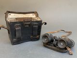 two old binoculars sitting next to each other on a table