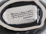 a black and white vase with a quote on it