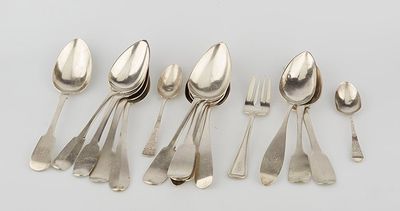 six silver spoons and a fork on a white surface