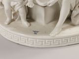 a figurine of a group of angels sitting on a pedestal