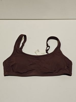 a close up of a brown bra top on a white surface