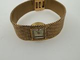 a close up of a wrist watch on a white surface