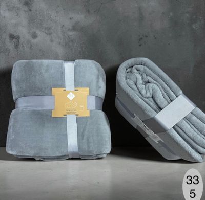 a couple of blankets sitting next to each other on top of a table