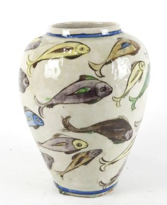 a white vase with a pattern of fish on it