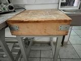 a small table with a wooden top in a kitchen