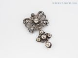 an antique diamond flower broochle and a pair of earrings