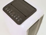 a small air conditioner sitting on a white surface