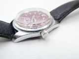 a close up of a watch on a black leather strap