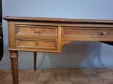 a wooden desk with two drawers on top of it
