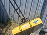 an image of a yellow machine that is leaning against a building