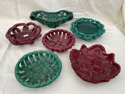 several different colored baskets are arranged on a white cloth