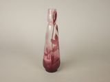 a glass vase with a pink flower inside of it