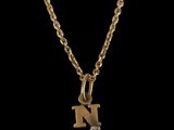 a gold initial necklace with a diamond on a chain