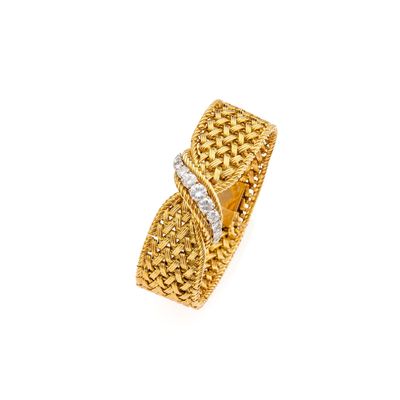 a close up of a gold and diamond ring on a white background