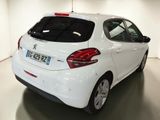 the rear end of a white car parked in a garage