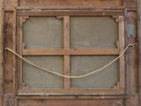 a wooden window with a rope around it