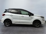 the white ford eco - pace suv is parked in a garage