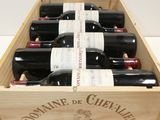 bottles of red wine in a wooden box on a table