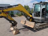 a picture of a small excavator parked in a parking lot