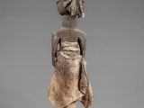 an image of a statue of a woman in a dress