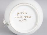 an image of a close up of a white vase with writing on it