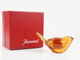 an image of a glass bird figurine in front of a red box