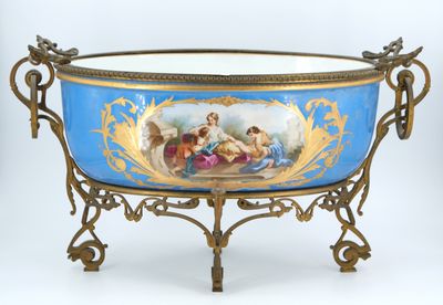 a blue bowl with a painting on it sitting on a stand