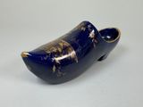 an image of a blue wooden shoe with a gold decoration on it