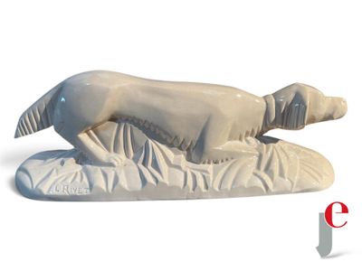 a statue of a dog laying down on a pillow