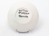 a white ball with a black writing on it