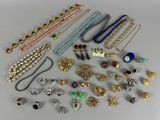 many different types of necklaces and bracelets on the table
