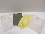 three pairs of shorts and a shirt sitting on a table