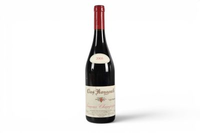 a bottle of red wine sitting on top of a white table