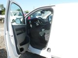 a white truck with its door open and a black seat in the back
