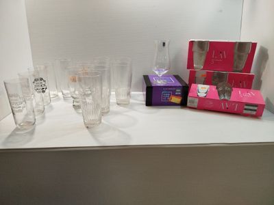de nombreux verres et boîtes posés sur le plan de travail de la salle de bains