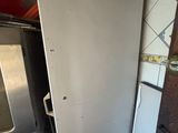 a refrigerator in the corner of a kitchen next to a stove