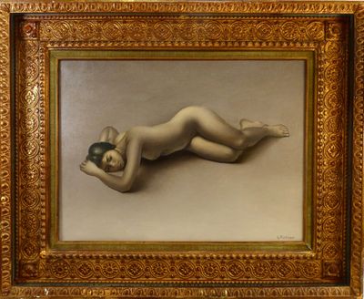 an image of a nude woman laying on her stomach in a gold frame